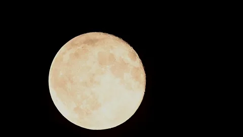 Full Moon rises through clouds in stunning 4k cinematic time lapse capturing the Stock Footage 305428344