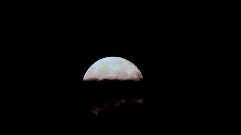 Full moon rises through clouds in dark sky during cinematic time lapse Stock Footage 305430014