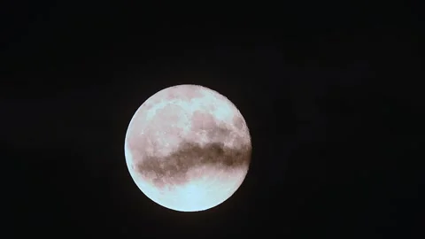 Full moon rises through drifting clouds in cinematic 4k time lapse of vibrant Stock Footage 305430793