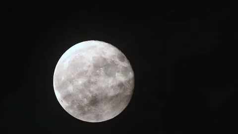 Full moon rises through drifting clouds in stunning time lapse revealing the Stock Footage 305430967