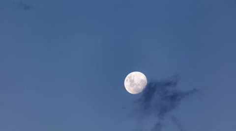 Full moon rising and clouds passing against blue sky time lapse 4k Stock Footage 64768049