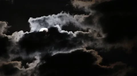 Full moon rising from behind the dark clouds Stock Footage 67276222