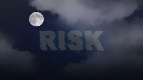 Full moon rising behind dark clouds with risk text overlay with moon positioned Stock Footage 340940563