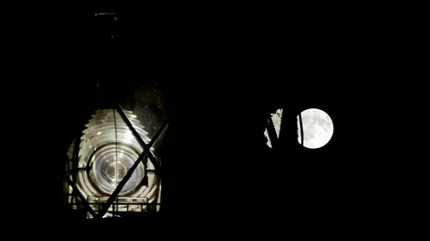 Full Moon Rising Behind the Maritime Lighthouse Stock Footage 80541515
