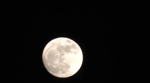 Full moon rising in night sky. Time lapse giving 3 times actual speed. Stock Footage 2918136