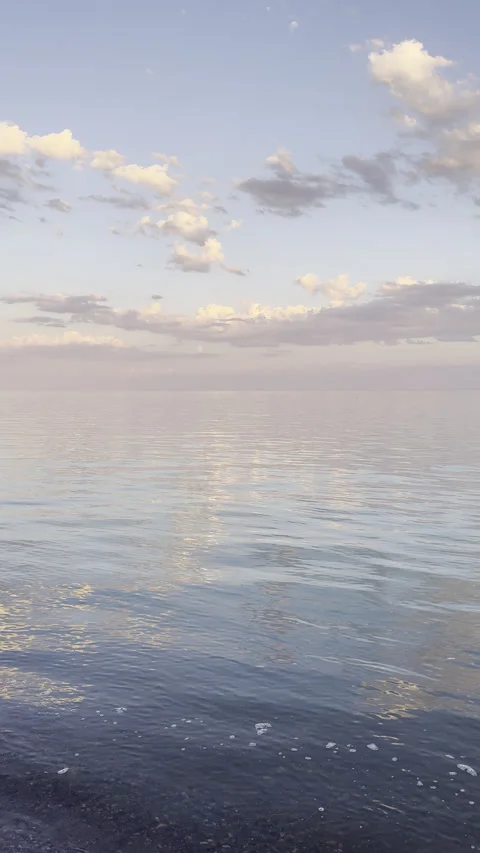 Full Moon Rising Over Calm Sea at Golden Hour Sunset Stock Footage 338330378