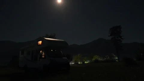 Full moon rising over a camper van in the mountains Stock Footage 340263989