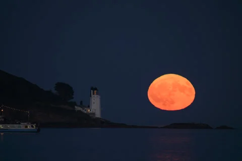 Full moon rising over St Anthony's lighthouse Stock Footage 331434623