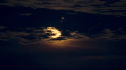 Full Moon Rising Timelapse in Dark Blue Evening Sky behind Clouds Stock Footage 249338541