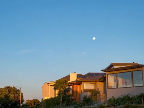 Full moon seen while setting sun Stock Photos