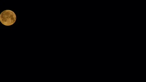 The full moon sets behind the house. Moon gradually descends in the black sky 動画素材 244058015