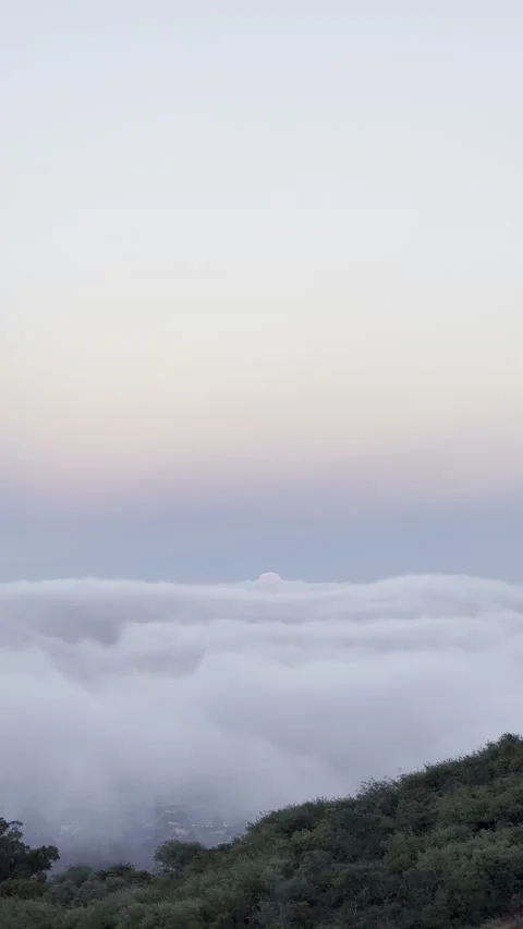Full Moon Setting Into a Dense Sea of Clouds Stock Footage 326641143