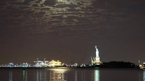 The Full Moon Setting next to the Statue of Liberty in New York City Video stock 68053719