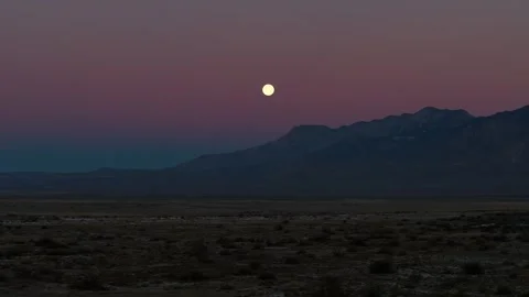 Full Moon Setting over Desert Mountains - Sunset or Sunrise Transition Timelapse Stock Footage 326841041
