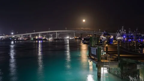 Full moon setting over the Paradise Island Bridge in the Bahamas Stock Footage 309814591