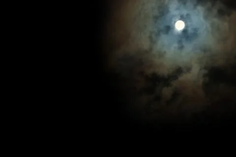 Full Moon shines through the clouds scary Stock Photos