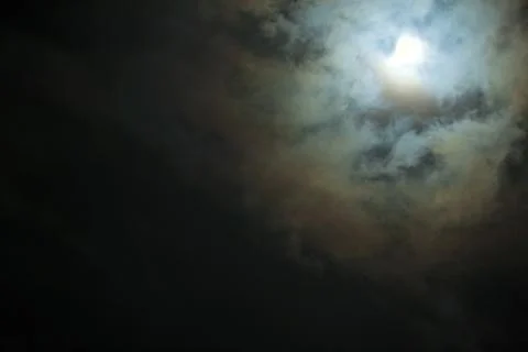 Full Moon shines through the clouds scary Stock Photos