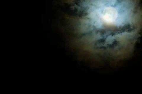 Full Moon shines through the clouds scary Stock Photos