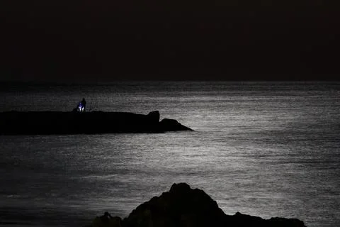 Full moon shining over Albufeira's tranquil waters Stock Photos