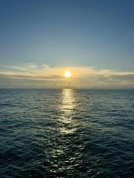 Full moon shining over the calm sea with a bright reflection on the water Stock Photos