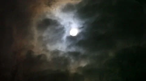 Full moon shining through the clouds and branches. Changes focus on blurred. HD Stock Footage 48082941