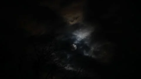 Full moon shining through clouds at night Stock Footage 152821140