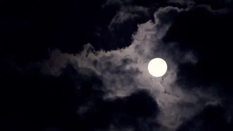 Full Moon Shining Through Dark Clouds at Night Stock Footage 339230661