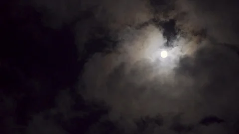 Full moon shinning through light clouds in dark night sky, 4K Stock Footage 95569187