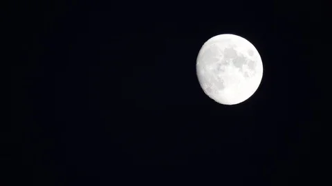 The full moon in sky moves across the horizon. Close-up moon, craters of moon Stock Footage 122290548