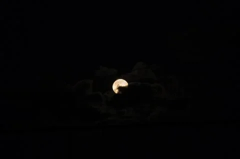 Full moon surrounded by clouds before the eclipse Stock Photos