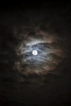 Full moon through layered clouds Stock Photos