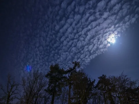 Full moon through smooth clouds and trees shadows. View Echichens Switzerland Stock-Footage 73581931