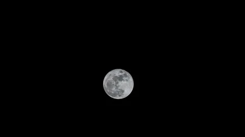 The Full Moon time lapsing through the night sky Stock Footage 306072285