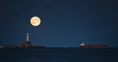 Full moon twilight landscape over sea horizon, lighthouse beacon Varna, Bulgaria Stock Footage 254374809