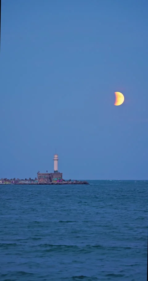 Full moon twilight landscape over sea horizon and lighting lighthouse Stock Footage 317266427