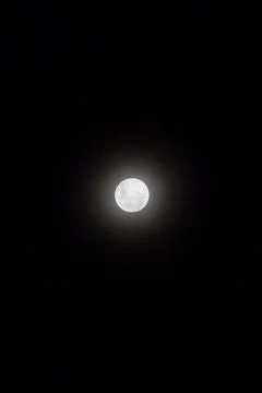 Full moon view isolated in dark black background, in the sky. Stock Photos
