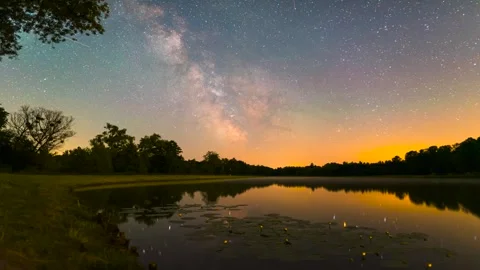 Full Night Milky Way Time-Lapse Over Lake with Yellow Water Lilies Reflection Stock Footage 327458236