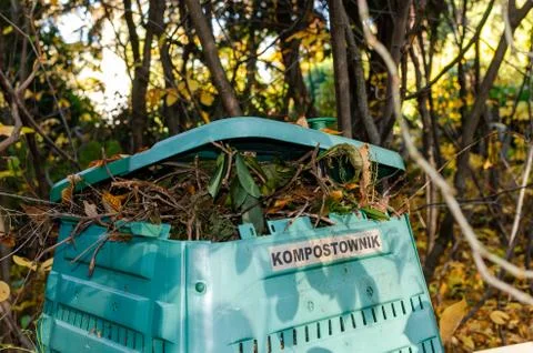 Full Outside plastic  compost container with leaves and branches. Text on pol Stock Photos