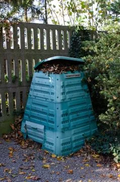 Full Outside plastic  compost container with leaves and branches. Text on pol Stock Photos