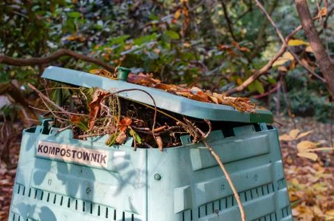 Full Outside plastic  compost container with leaves and branches. Text on pol Stock Photos