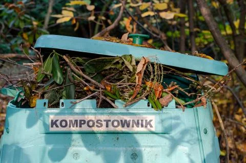 Full Outside plastic  compost container with leaves and branches. Text on pol Stock Photos