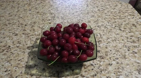 Full Plate of Red Cherry is Standing on Tabletop Stock Footage 64279343