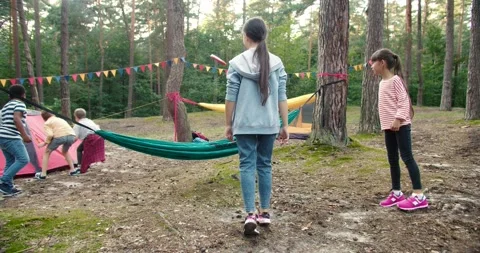 Full rack focus shot of happy kids relaxing outdoors at the camp at the forest Видео 162117905