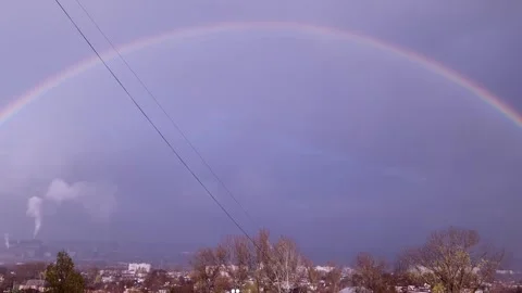Full Rainbow Arcs Over Stormy Industrial Cityscape Stock Footage 325223145