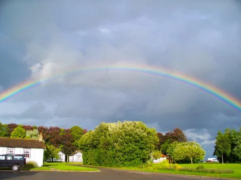 A Full Rainbow Over Trees Stock Photos