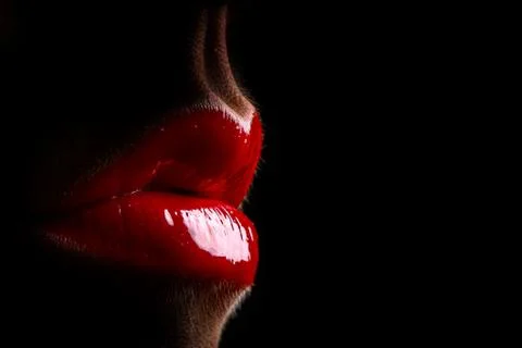 Full red lips an black background Stock Photos
