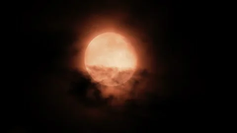 Full red moon rising in night sky covered by dark moving clouds cinematic f.. Stock Footage 339373373