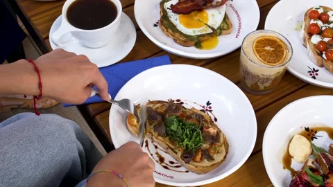 Full Restaurant Brunch Table with Sweet and Savory Dishes, Coffee and Iced Tea Stock Footage 336418246