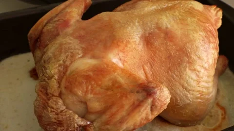 Full roasted chicken meat in a baking dish close up Stock Footage 311797875