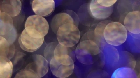Full screen blue and gold bokeh background glowing on black close-up Stockbeeldmateriaal 317533762
